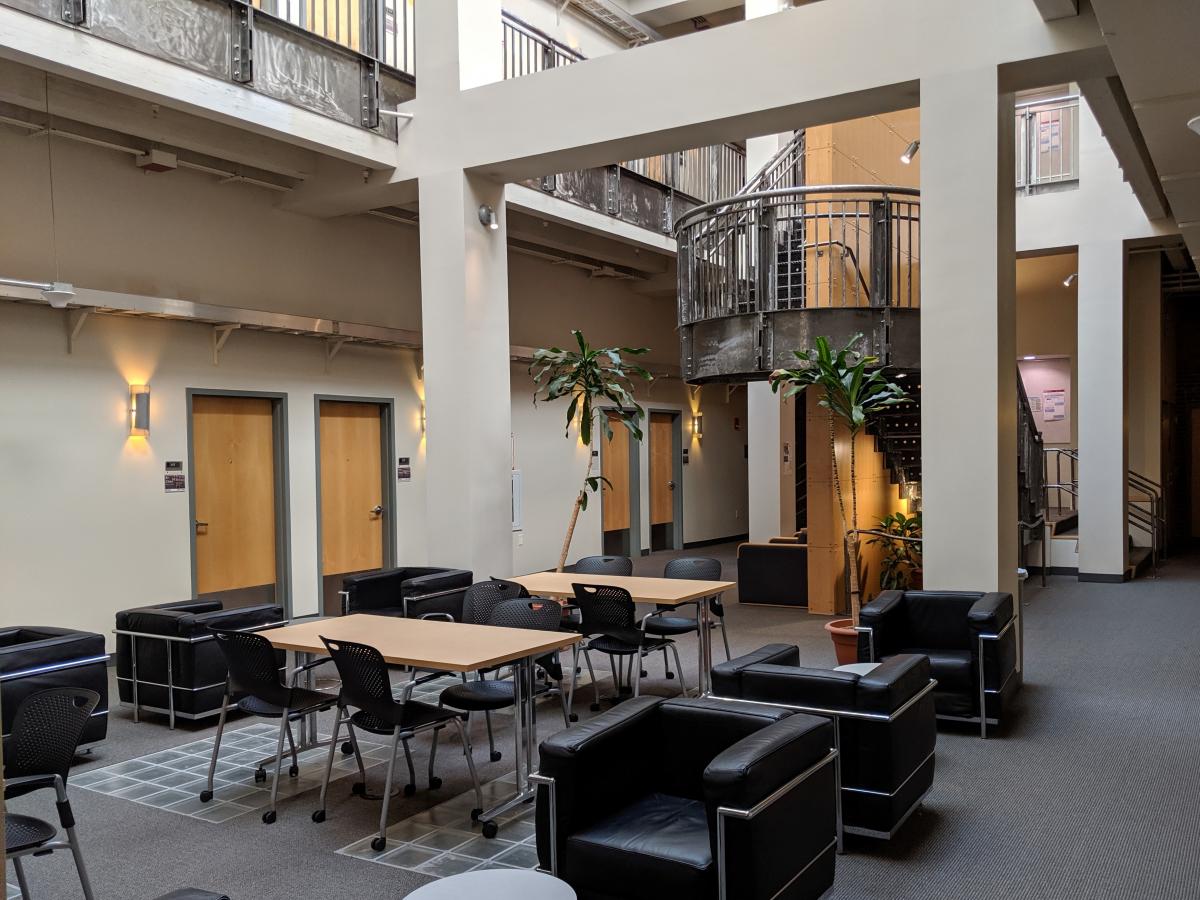 An atrium lounge with seating and tables