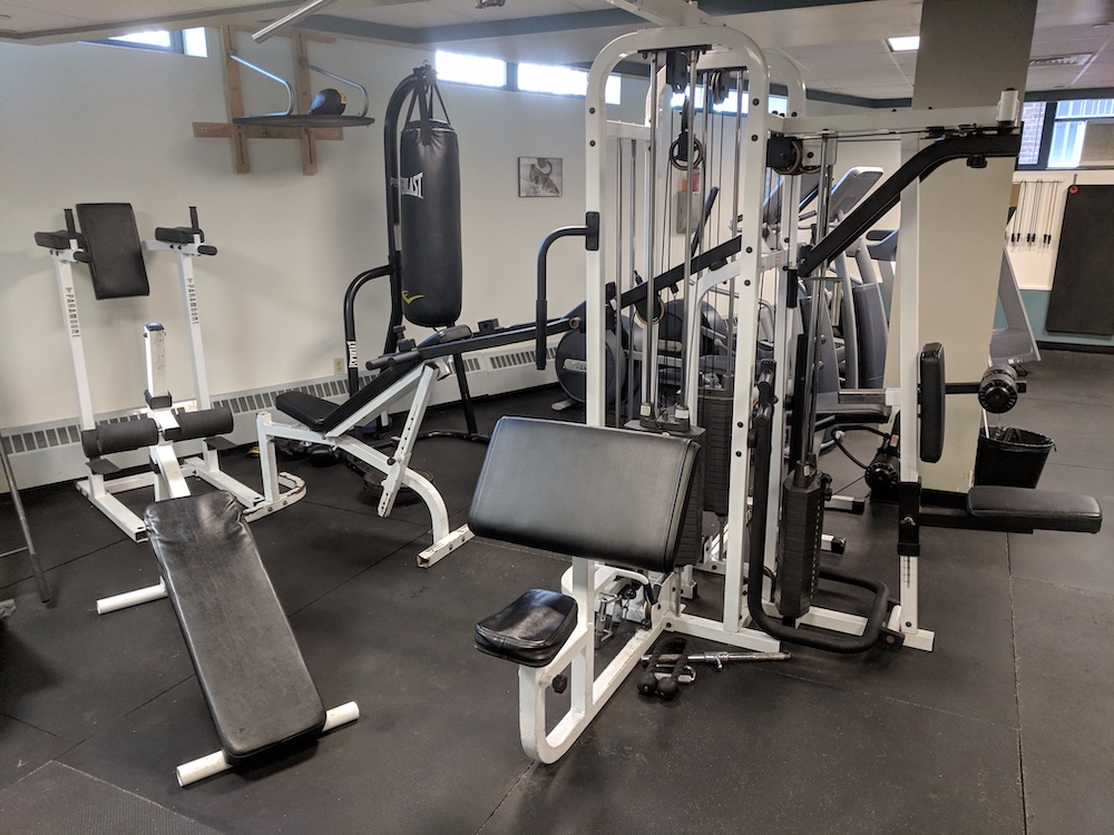 A fitness room with strength training equipment