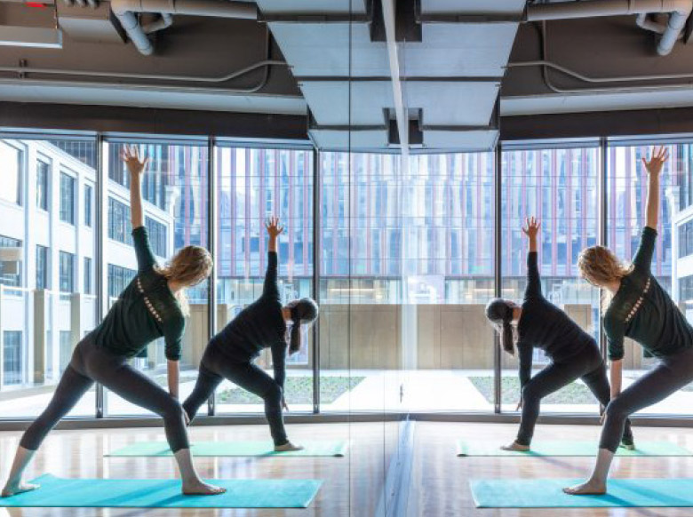 People practicing yoga in a graduate residence amenity space