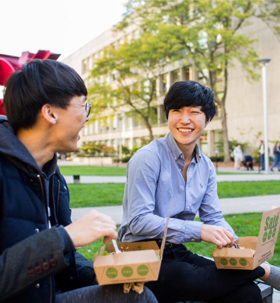 MIT students eating together on the lawn